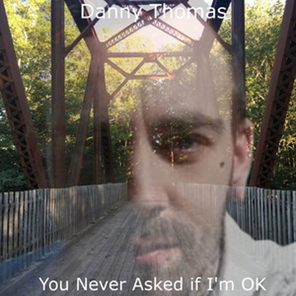 You Never Asked If I'm OK cover art: Danny Thomas's face blended over an old steel bridge